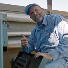 An Advantage Air Mechanical technician wearing a branded shirt giving a thumbs up to the camera