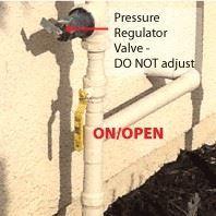 water pressure regulator valve with a label that suggests not to adjust the valve